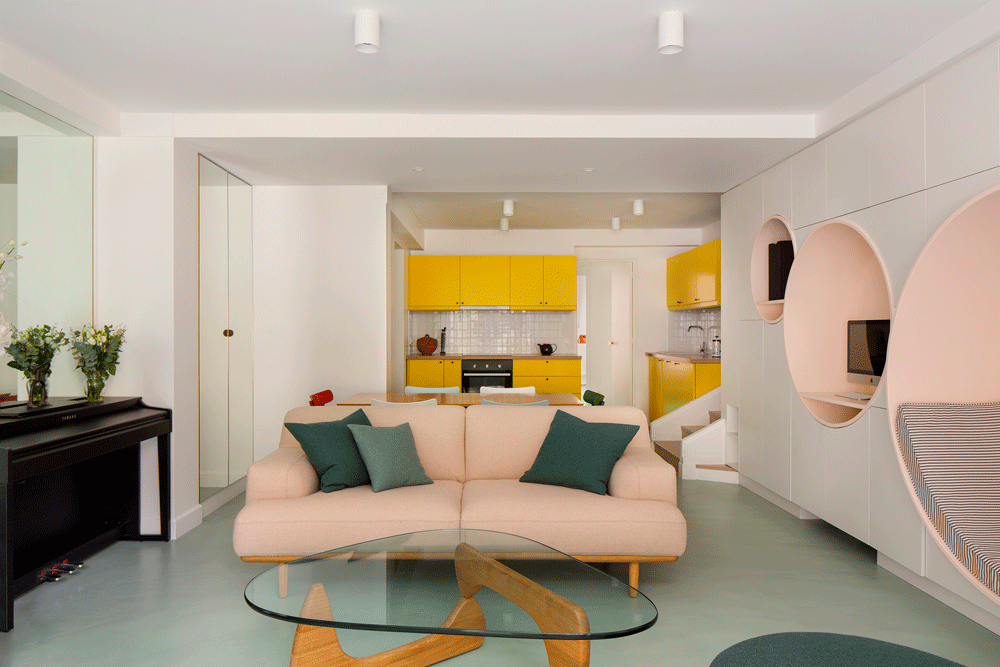 The living room of a Neuilly-sur-Seine apartment renovated by Atelier Pierre Louis Gerlier, complete with circular reading nooks and a pastel color palette.