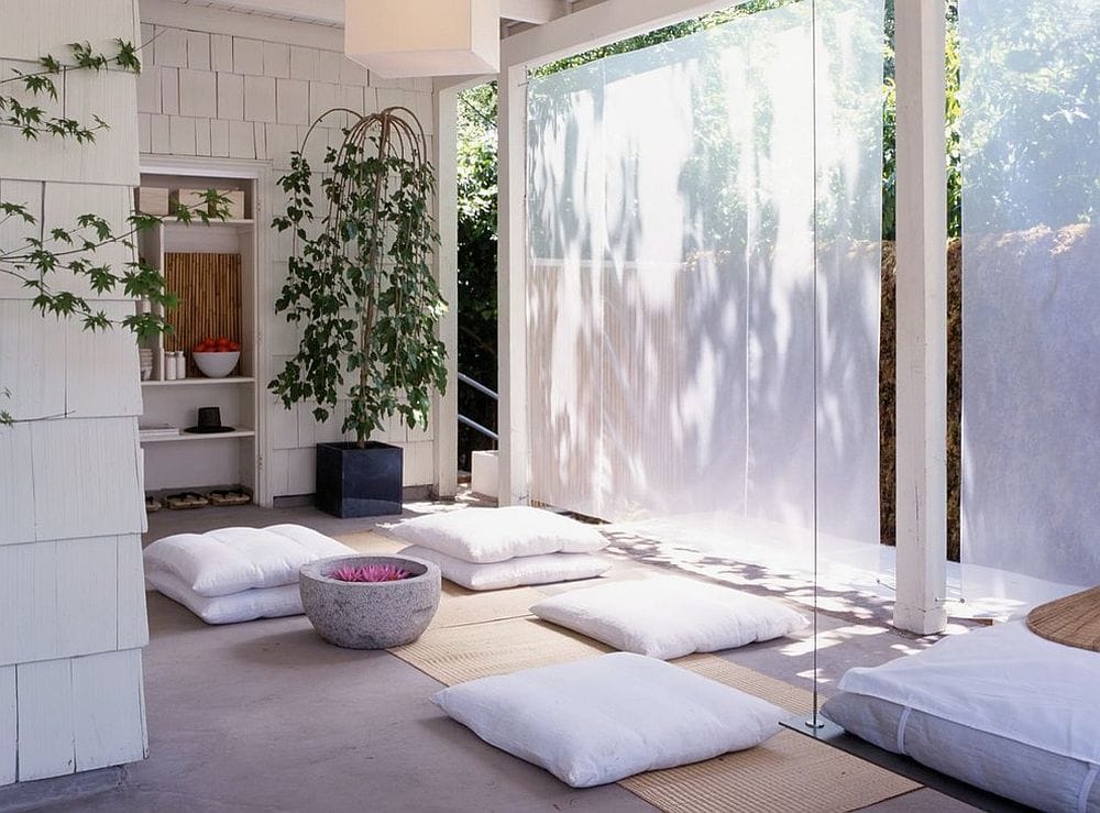 Mostly white room with floor cushions for seats does a great job of capturing a zen feeling.