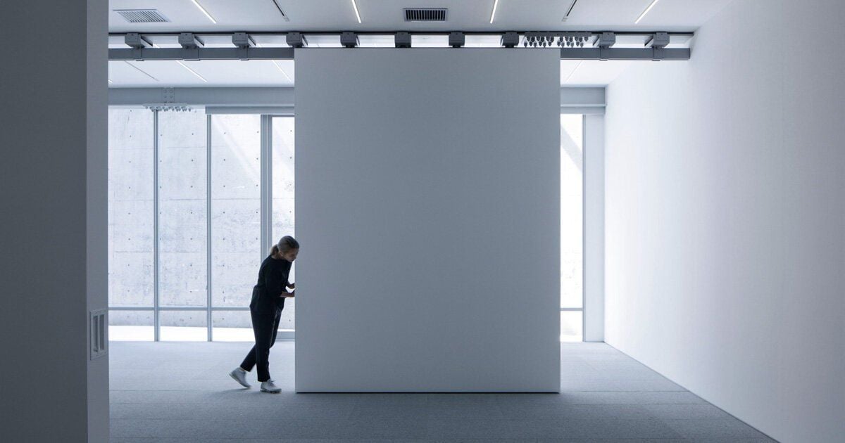 Side view of person pushing a Gallery COMMON movable wall to quickly change the space's layout.