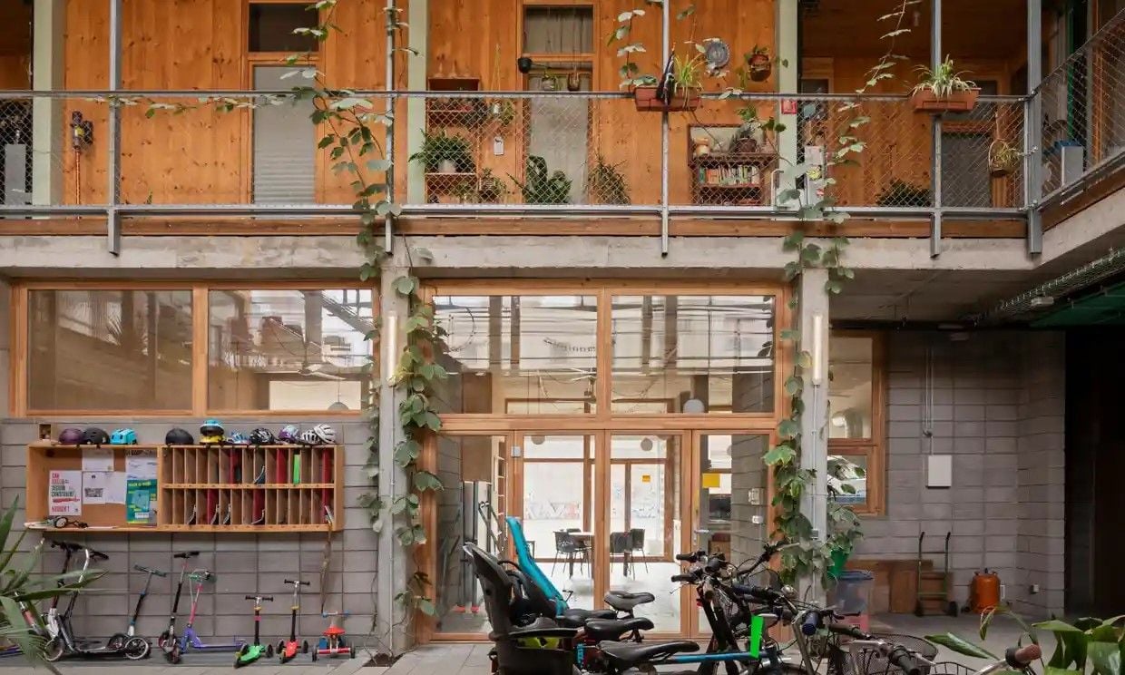 Industrial-style bike and scooter storage inside La Borda housing co-op.