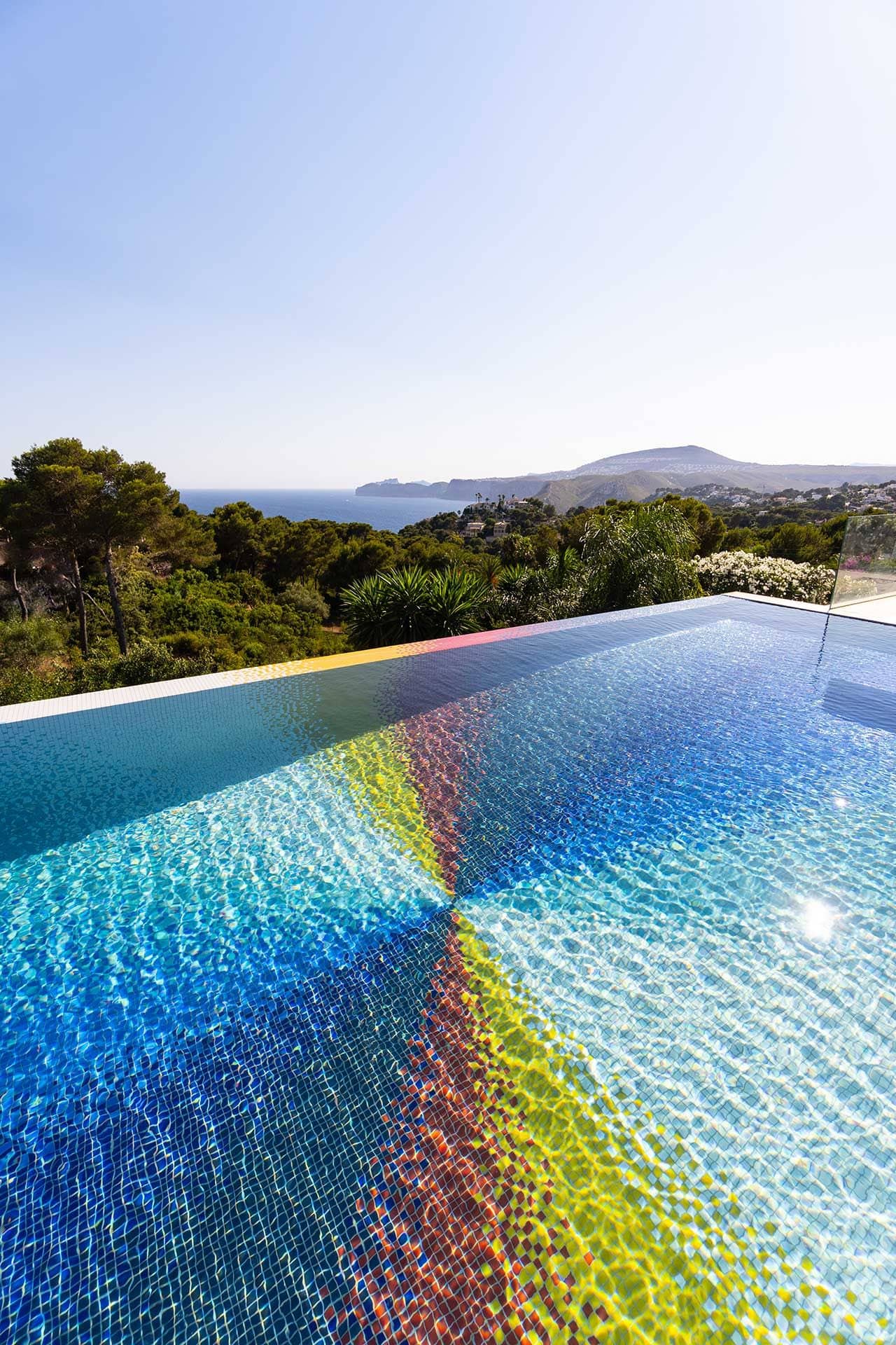 Gorgeous pinwheel color pattern on the bottom of a residential swimming pool by Felipe Pantone.