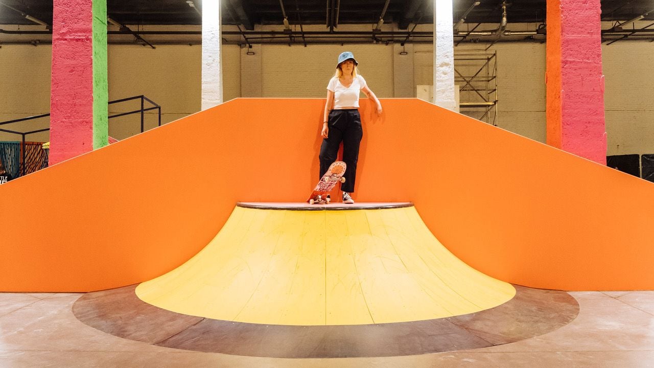 Young skater prepares to coast down this bright orange 