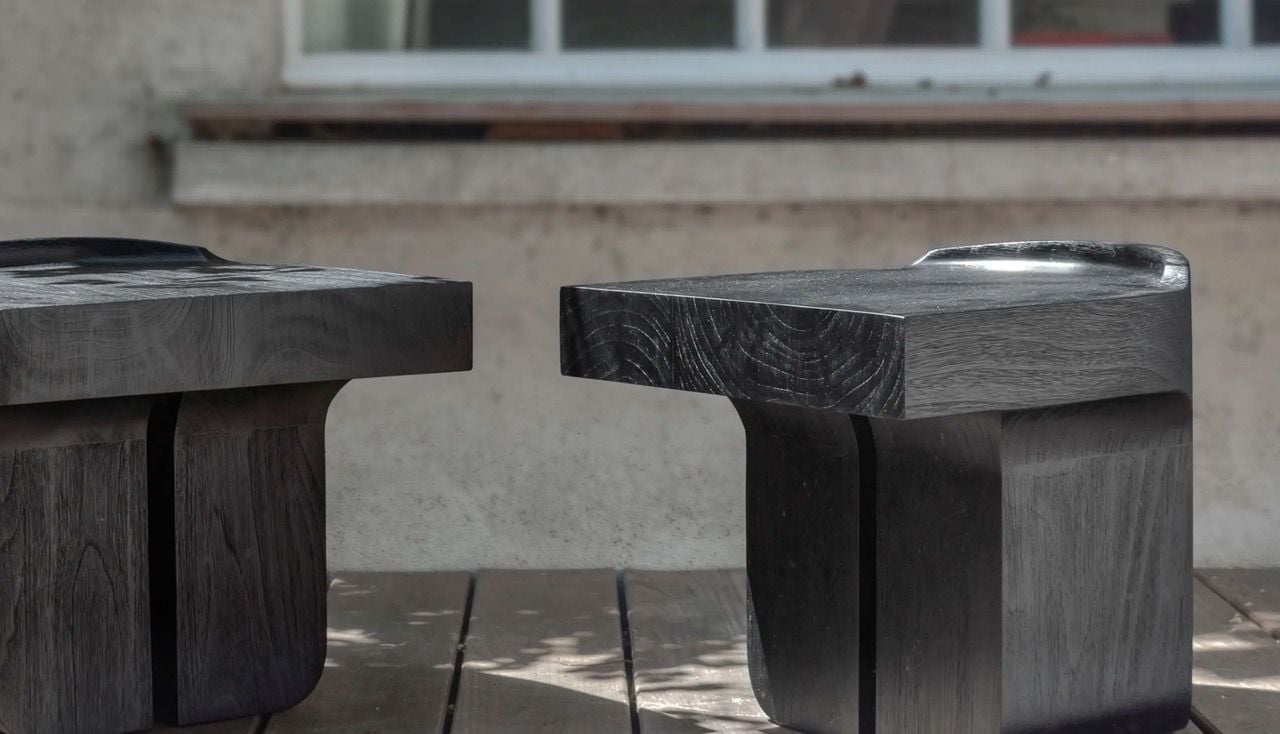 Black teak Cuddle stools by Atelier Pendhapa come together and separate depending on the users' preferred proximity. 