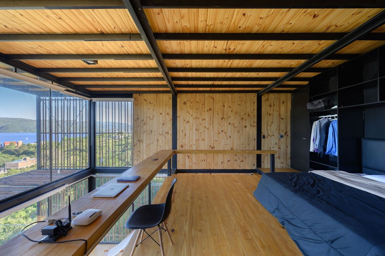 Expansive minimalist bedroom and workspace inside the the Pablo Senmartin-designed Bioclimatic House.