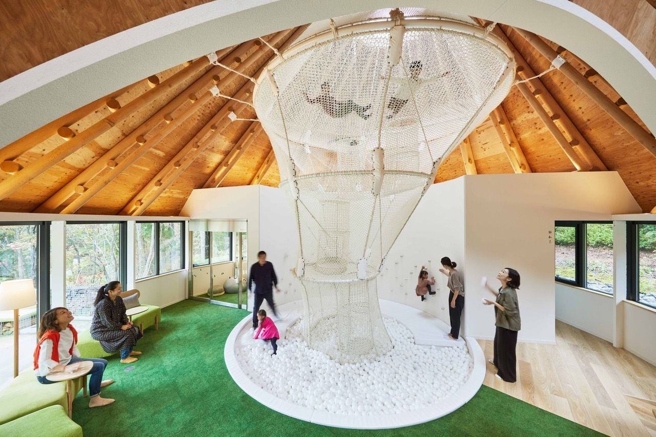 Kids play inside a large net structure inside the PokoPoko Fairytale Club House  