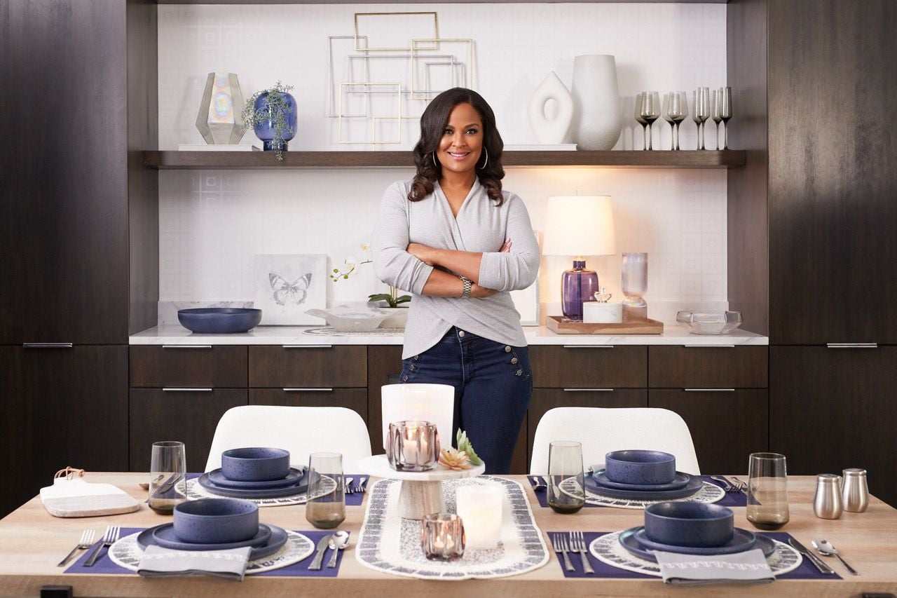 Laila Ali stands in a room filled with pieces from her new decor collaboration with At Home. 