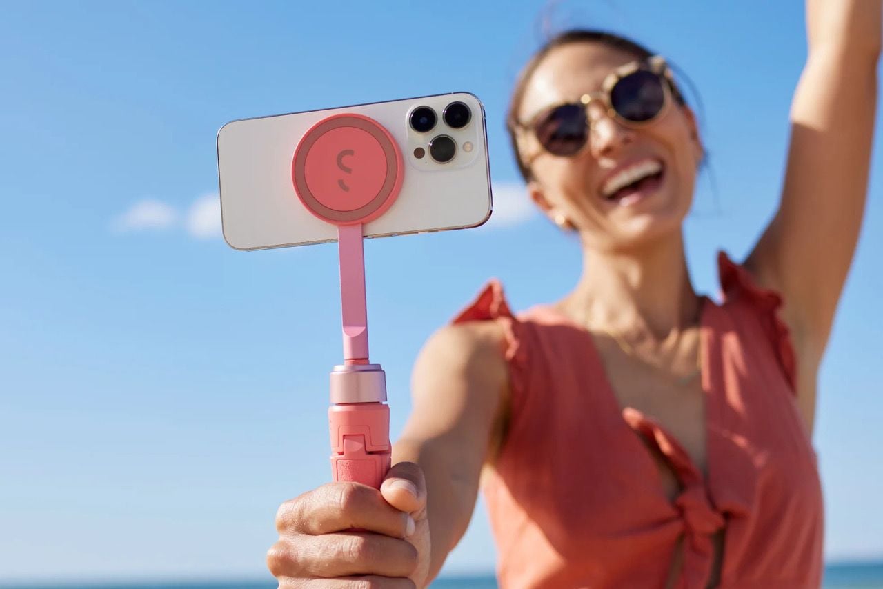 Woman snaps a selfie with ShiftCam's SnapPod selfie stick.