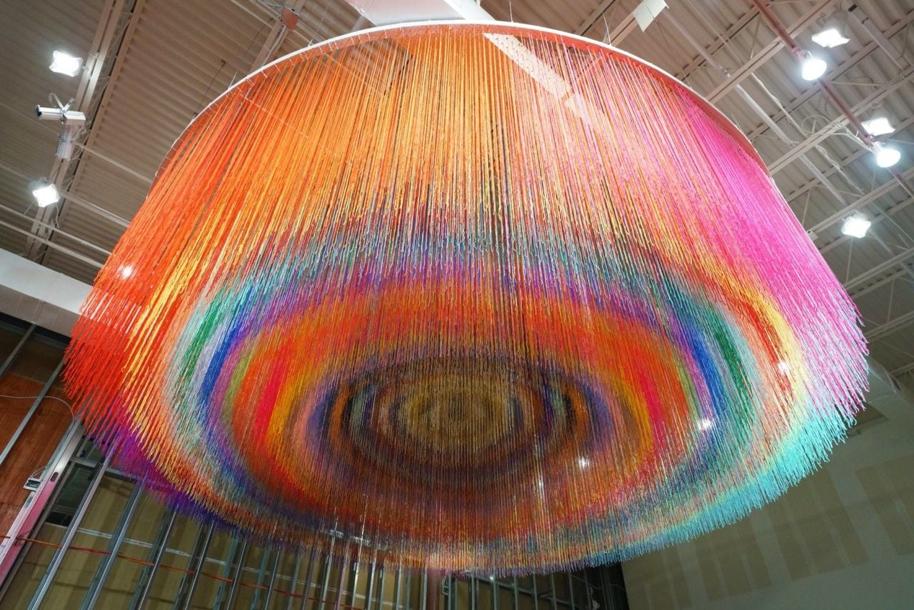 Colorful hanging yarn installation by HOTTEA.