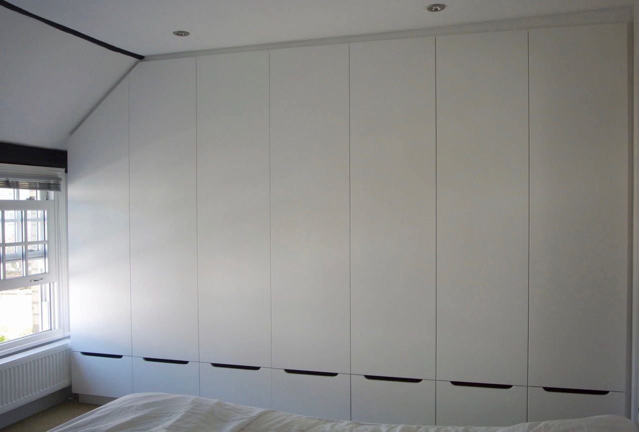 Invisible closet in a UK apartment by interior designer Kate Polak. 