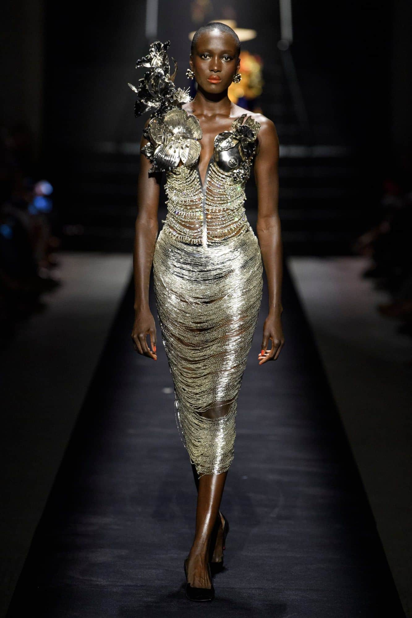 Schiaparelli-designed dress at Paris Fashion Week 2022 combines the event's prominent metallic and floral themes. 