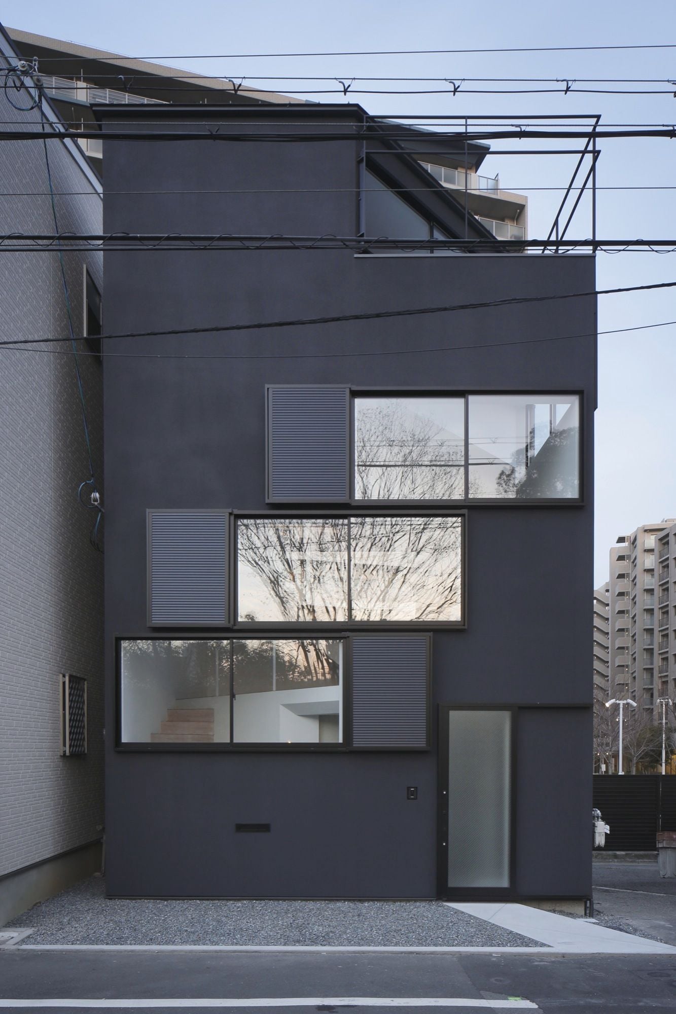 Visually striking geometric facade of a family home in Osaka, designed by Alphaville Architects.