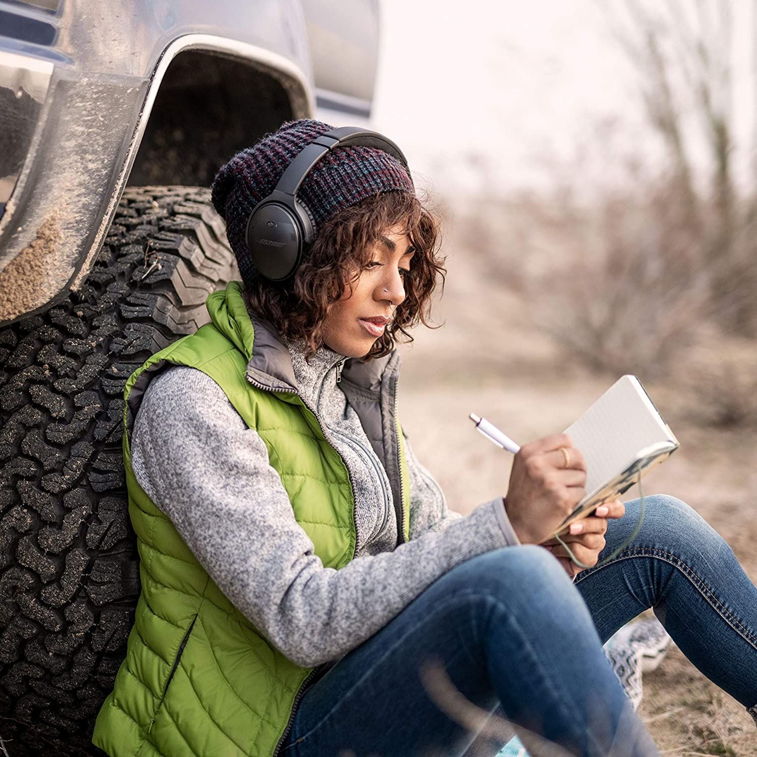 Young woman listens to music on her Bose Quiet Comfort Wireless Bluetooth Headphones.