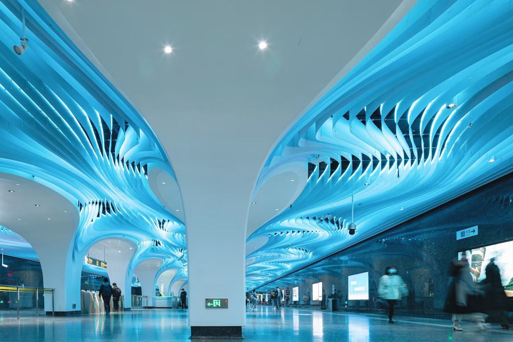 Renovated Yuyuan Station ceilings by XING Design glow an ethereal blue color.