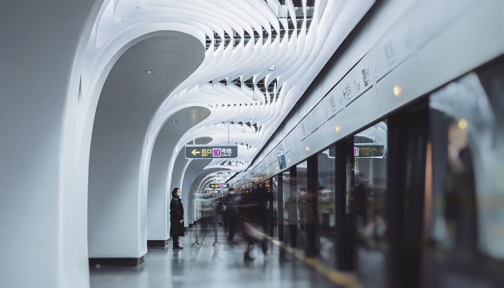 Shanghai metro passengers board trains underneath the magnificent LED ceilings of the renovated Yuyuan station. 
