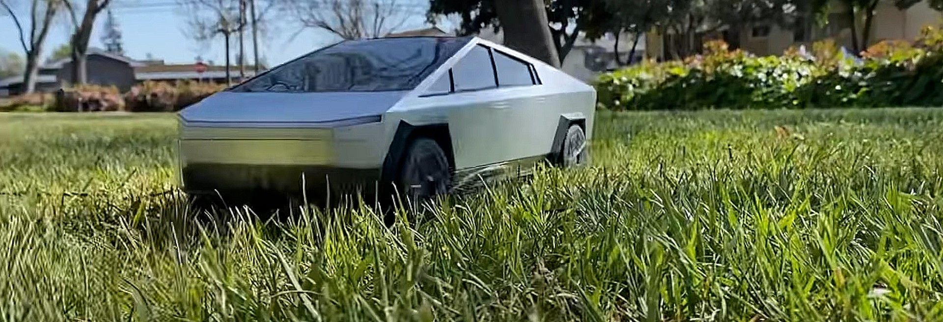 Hot Wheels 1:10 Scale R/C Tesla Cybertruck hangs out in some grass.