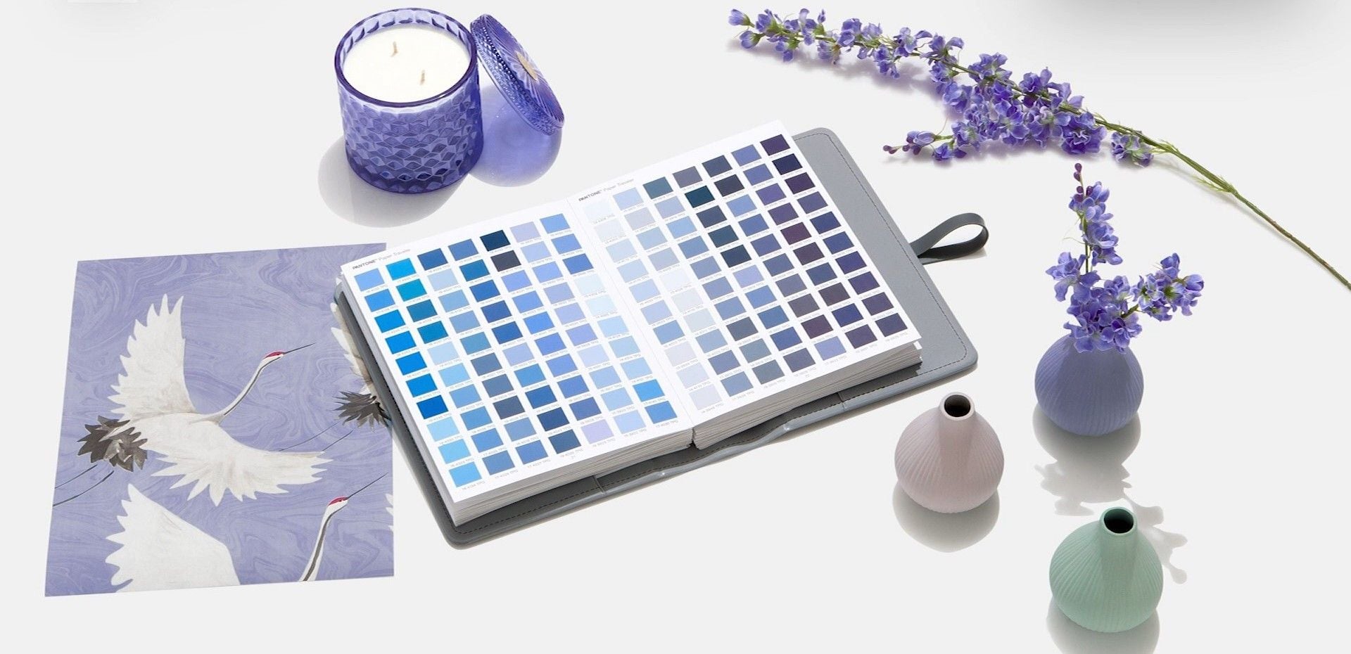 Pots, paintings, and a color swatch book open to Pantone blues and purples all give one a better idea of 