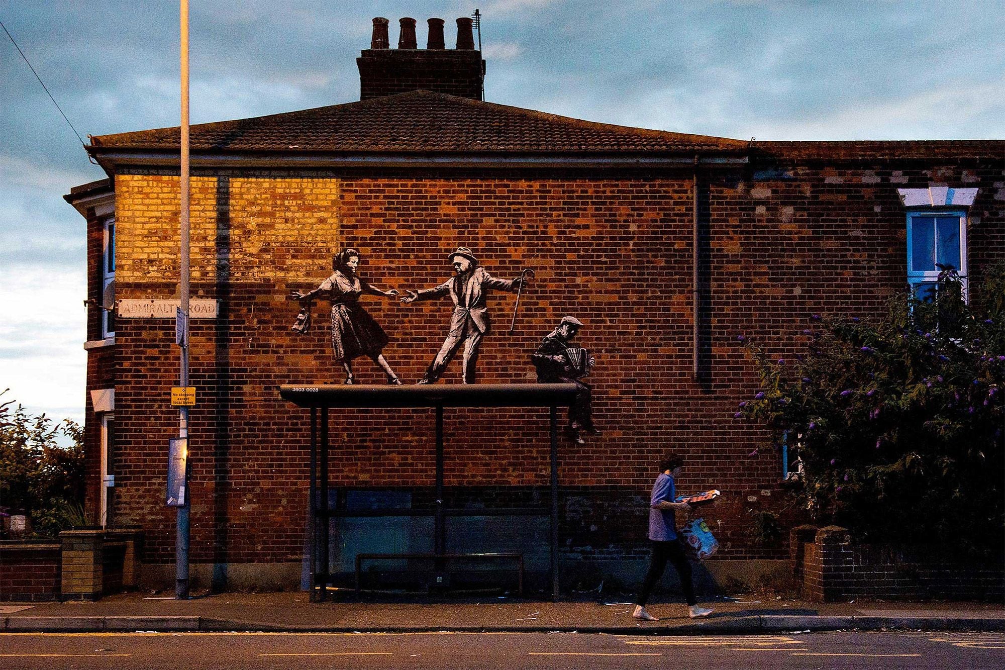 People appear to dance atop a Norfolk bus stop in this fun new Banksy mural.