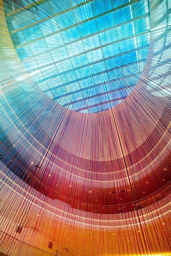 View up at a large hanging yarn installation by HOTTEA. 