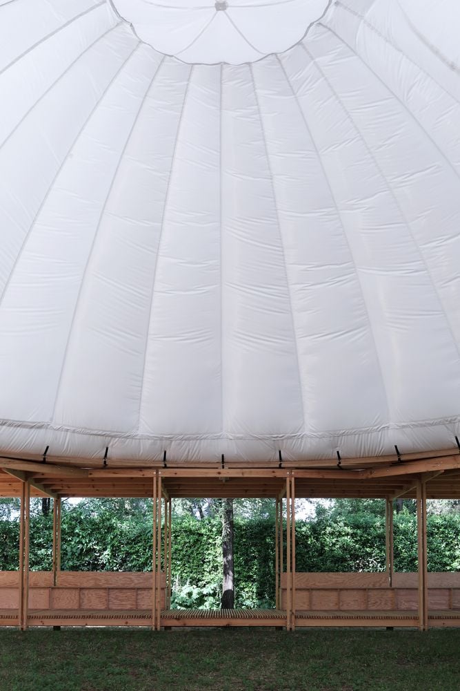 Underneath the expansive white canopy of Rome's inflatable ProtoCAMPO pavilion.