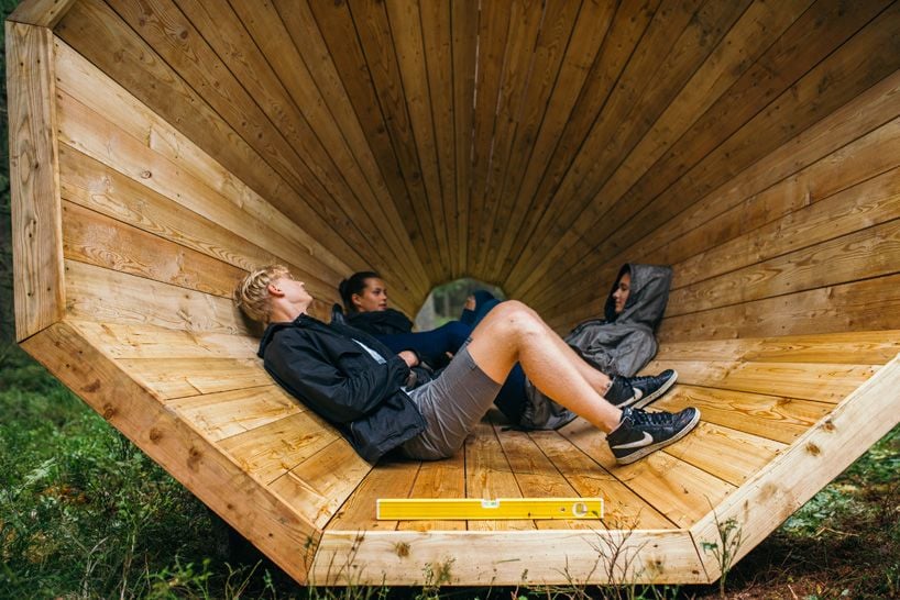 Travelers lay down inside a RUUP megaphone to experience the amplified sounds of nature.
