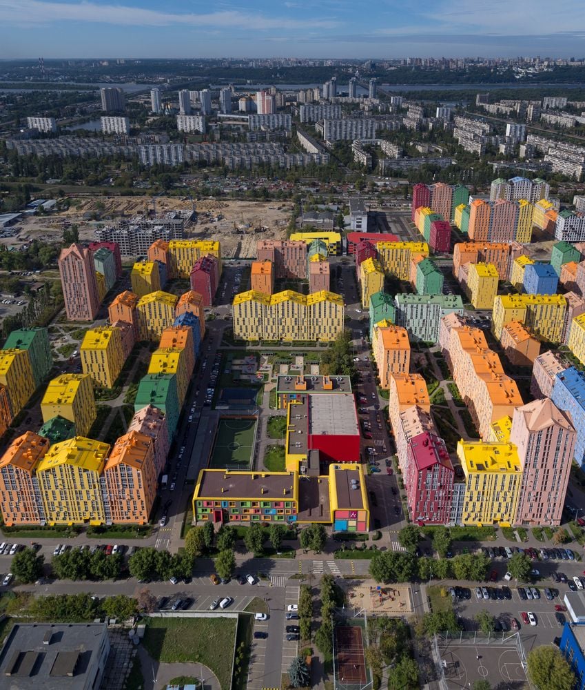 Aerial view of the tall, colorful buildings that make up Archimatika's Comfort Town housing development in Kyiv, Ukraine.