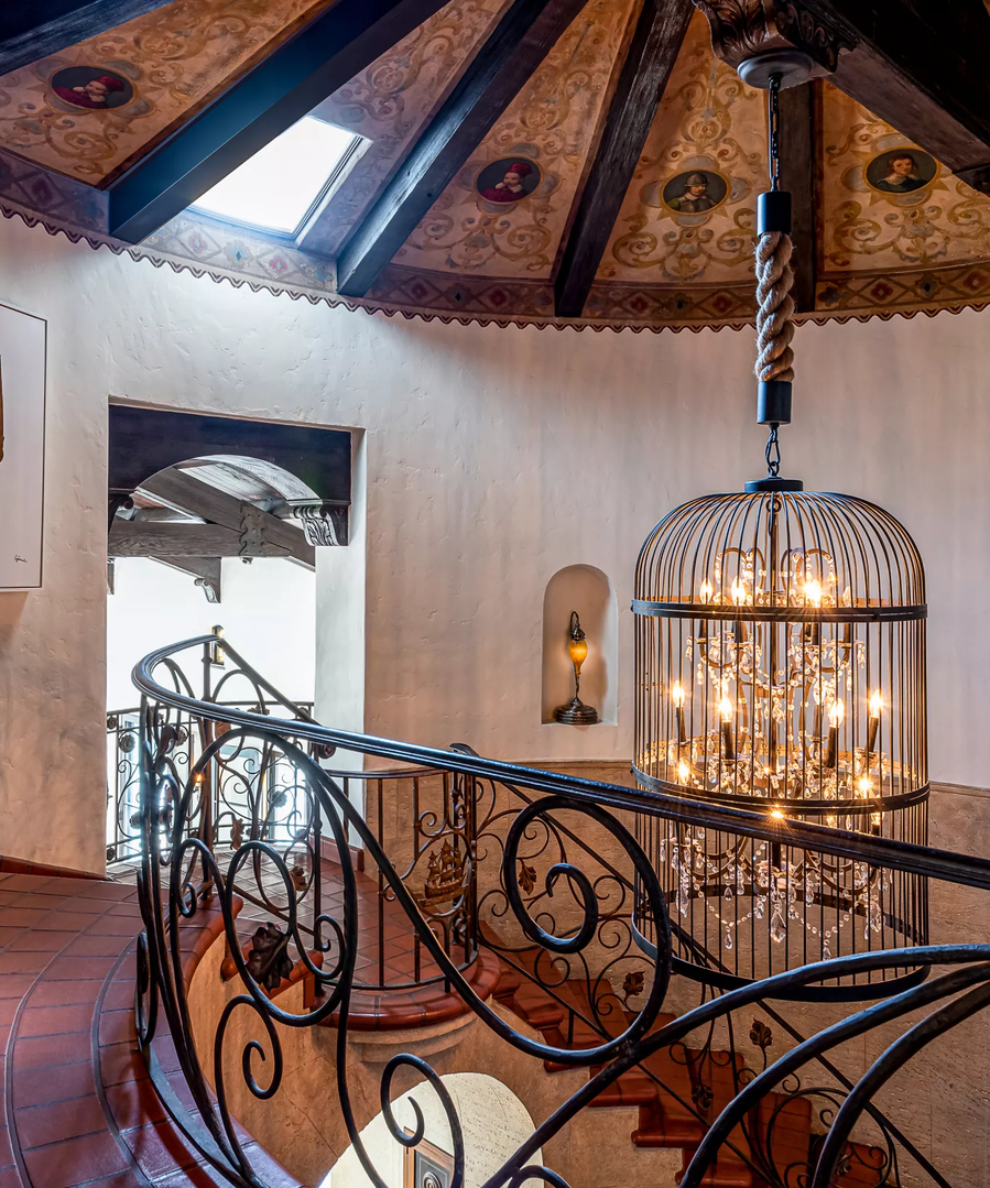 Impressive sculptural chandelier hangs in the mostly terracotta foyer of Leonardo DiCaprio's new LA home.