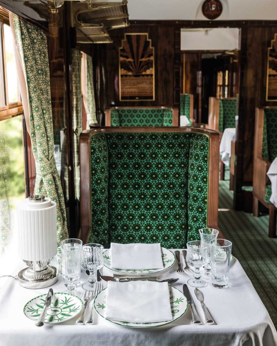 Quaint symmetrical dining table in Anderson's restored train carriage looks like something pulled straight from one of his movies.