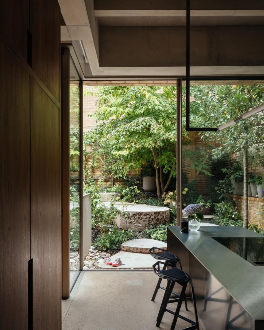 Large glass walls and an outdoor garden space lend the renovated house on Primrose Hill a connection to the outdoors.