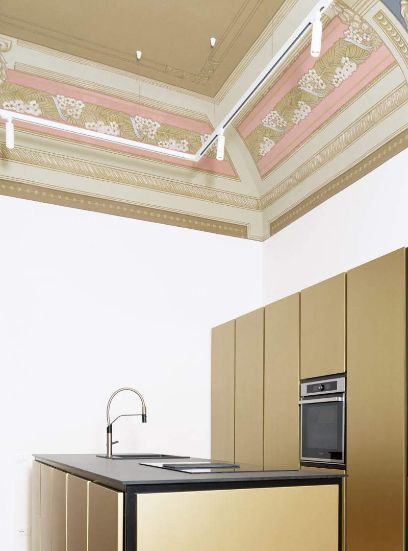 Muted gold cabinets make up the bulk of the Lelefante apartment's kitchen space.
