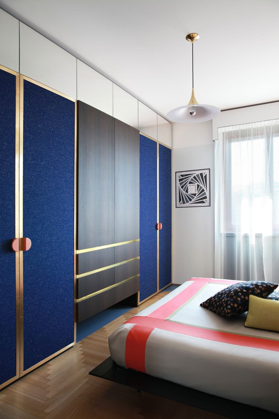 Rich blue doors line a wall inside Teorema Milanese's master bedroom