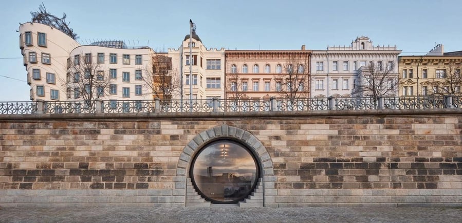 Large transparent entrance to one of Prague's many arched Vltava River vaults, restored by Brainwork Studio. 