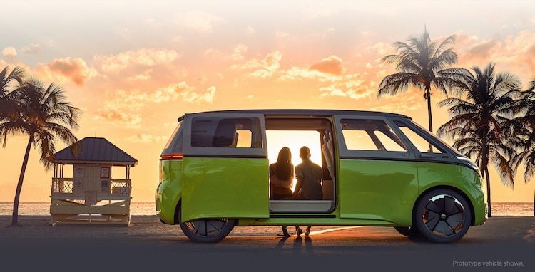 Couple watches the sunset from the comfort of their fully electric Volkswagen I.D. Buzz.