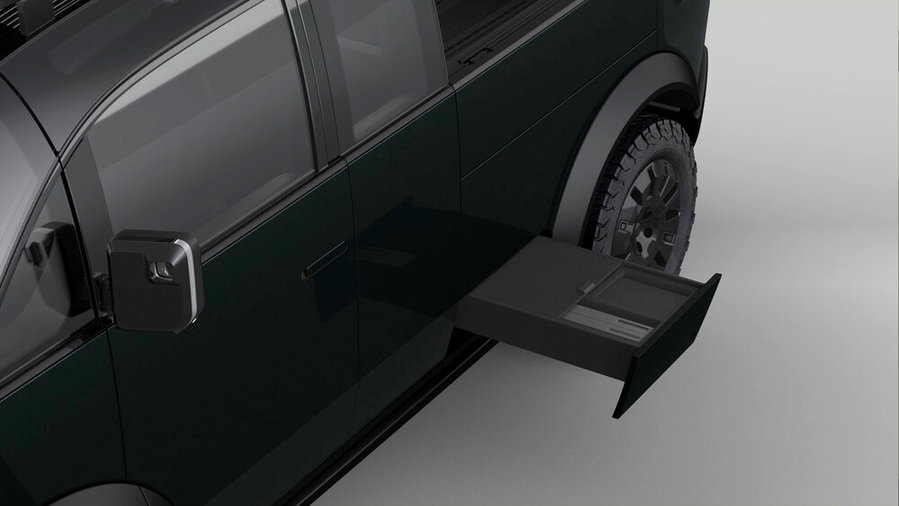 Hidden side steps like this one also fold out of the Canoo electric pickup truck.