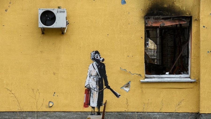 Banksy mural in Borodyanka, Ukraine depicts a woman in a gas mask bearing a fire extinguisher.
