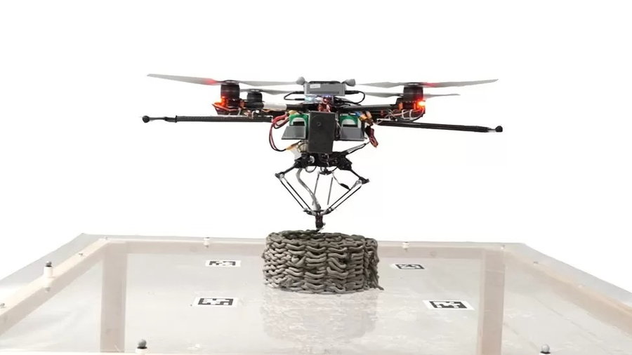 Bee-like 3D printing drone assembles a concrete structure from above.