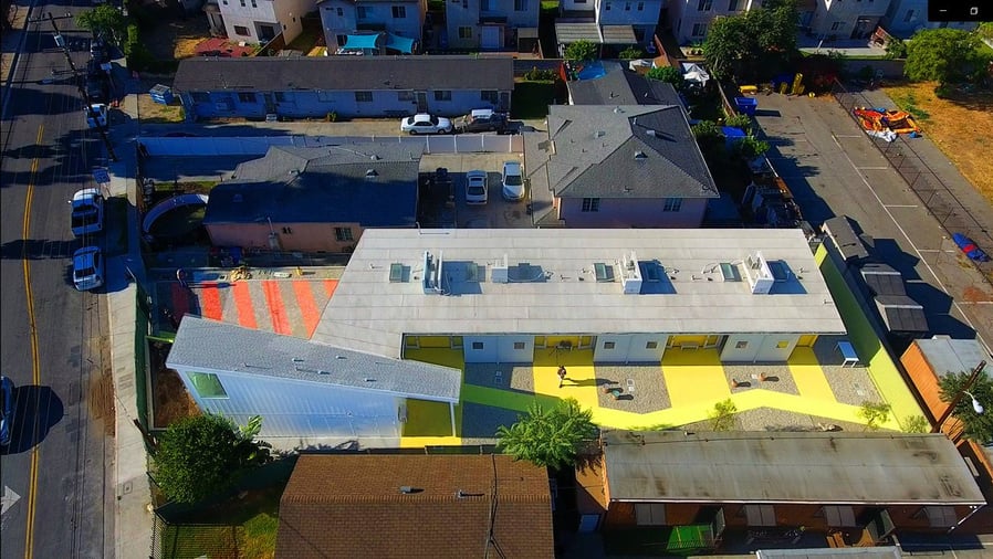 Aerial view of LA's bright Willowbrook Apartments for disabled veterans.