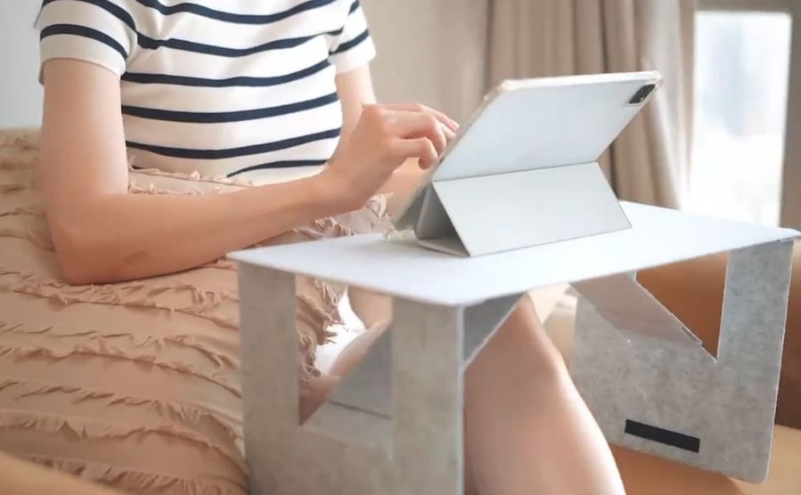 iSwift M portable laptop desk propped up to support a person's tablet