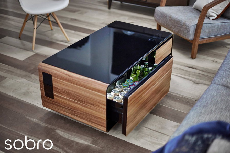 The Sobro Smart Coffee Table set up in a contemporary living room, with its refrigerated drinks drawer pulled slightly open.