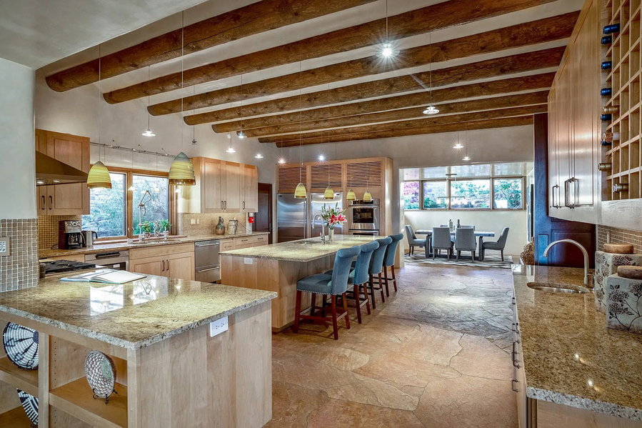 Open plan kitchen and dining area at 1432 Old Sunset Trail, a sprawling Santa Fe mansion on the market for $8.5 million.
