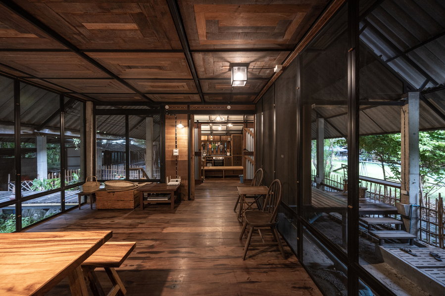 Large glass walls and ample natural light almost make the Kha-Nam Noi's house's interiors feel like they're out side.