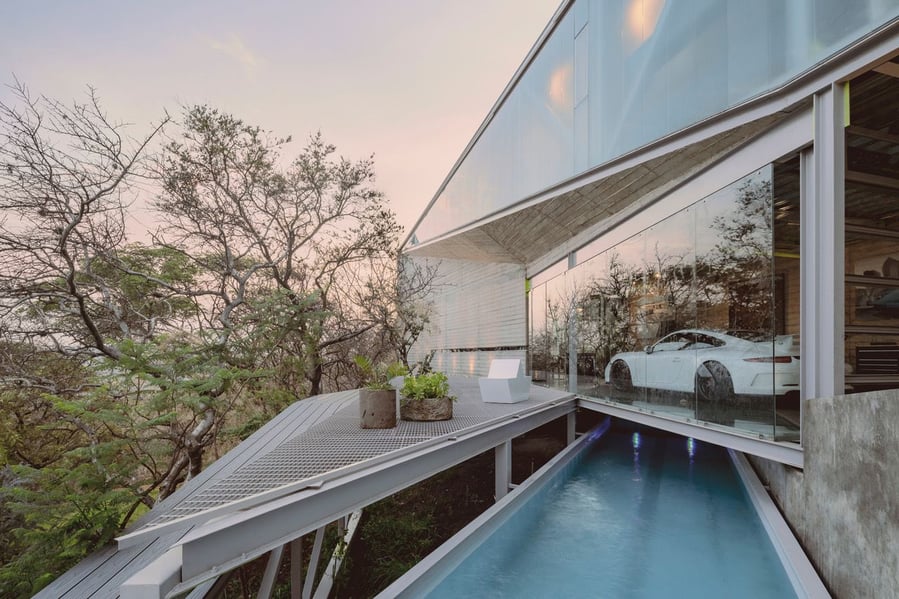 Casa Cañadas' translucent garage (located directly above a sleek narrow swimming pool) makes the car inside the home an artwork entirely on its own.