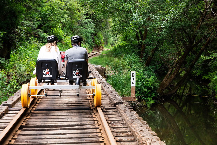 Couple zips through the California redwood forests on an all-electric Skunk Train railbike. 