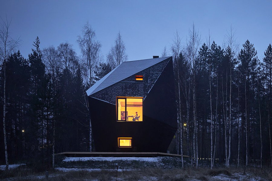 The Ateljé Sotamaa-designed Meteorite cabin gives off an otherworldly glow in the Finnish forest at dusk.  