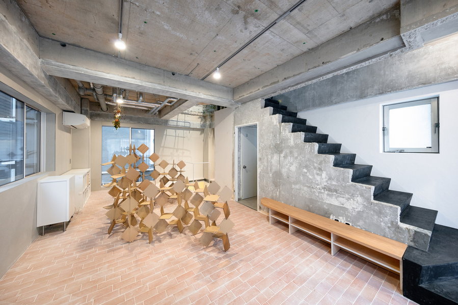 Raw concrete office space inside MAMM Design's renovated Tokyo residence. 