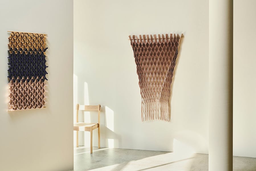 Honeycomb-like hanging textiles from the FLOW collection bring splashes of color and elegance to a modern living space.