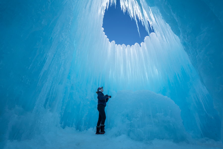 Woman snaps a photo inside one of Brent Christensen's crystalline ice castles.