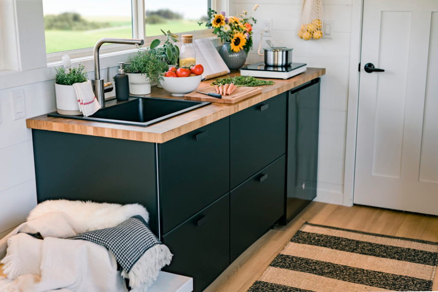 A small, sleek kitchen area inside IKEA's new tiny home offering, made in collaboration with RV manufacturer Escape.