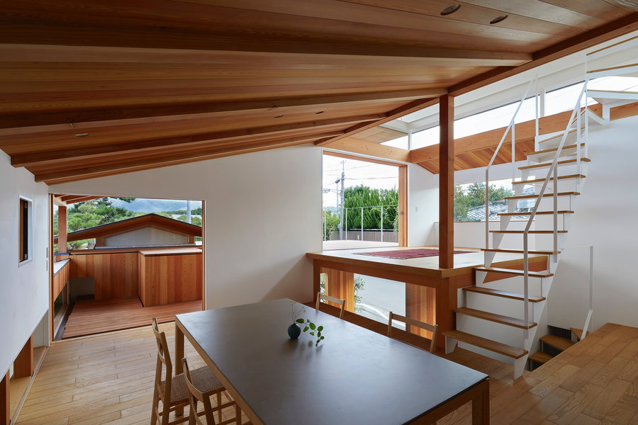 Open dining room are in the House in Shimogamo features several exits to the home's outdoors areas and upper floors. 