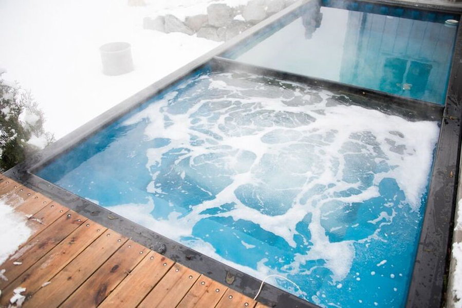 Use a divider to turn half of your shipping container pool into a steamy hot tub. 