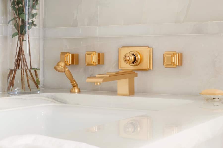 Ornate golden bathtub set custom-designed by Sherle Wagner.